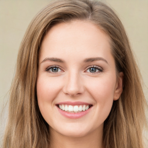 Joyful white young-adult female with long  brown hair and green eyes