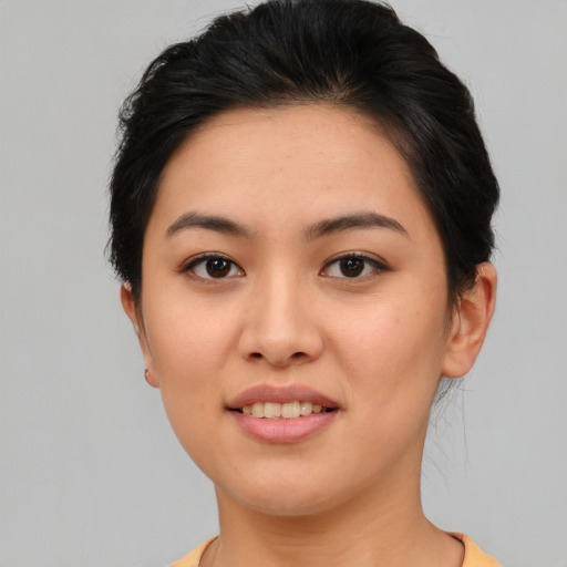 Joyful asian young-adult female with short  brown hair and brown eyes
