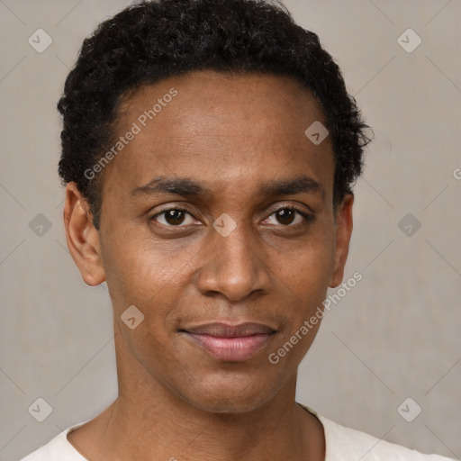 Joyful black young-adult male with short  black hair and brown eyes