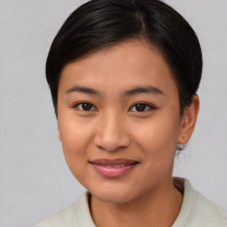 Joyful asian young-adult female with medium  brown hair and brown eyes