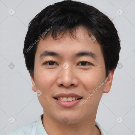 Joyful asian young-adult male with short  black hair and brown eyes