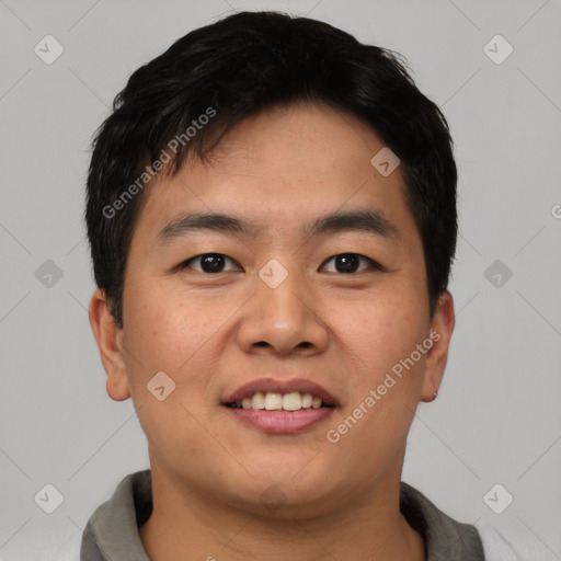 Joyful asian young-adult male with short  black hair and brown eyes