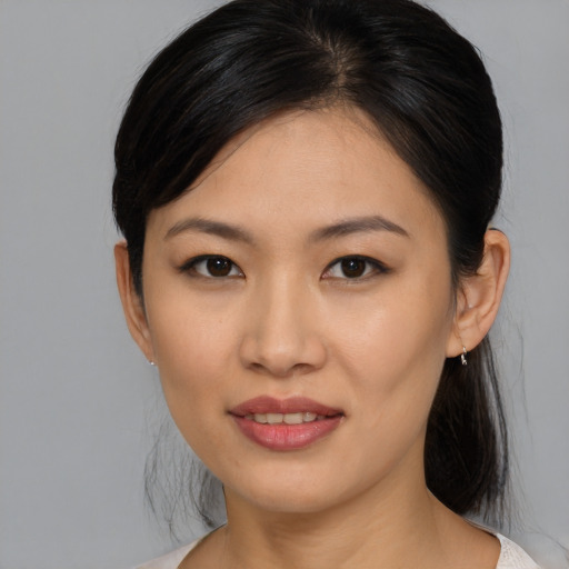 Joyful asian young-adult female with medium  brown hair and brown eyes