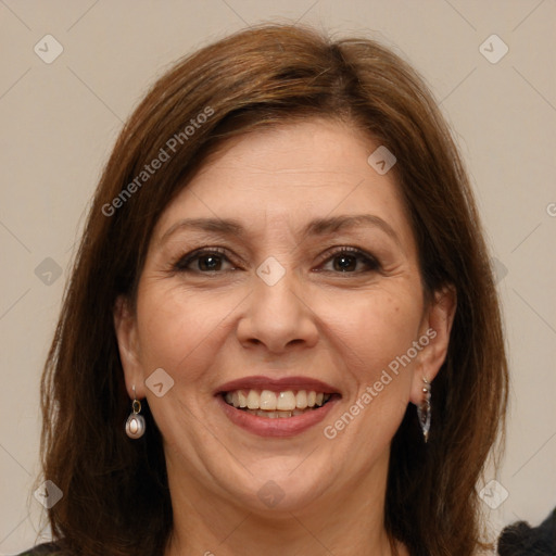 Joyful white adult female with long  brown hair and brown eyes