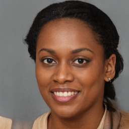 Joyful black young-adult female with long  brown hair and brown eyes