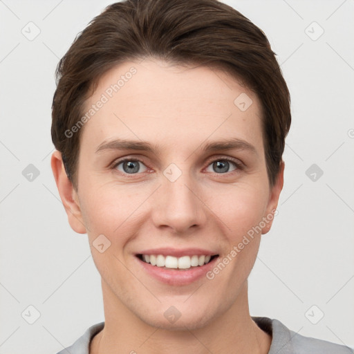 Joyful white young-adult female with short  brown hair and grey eyes