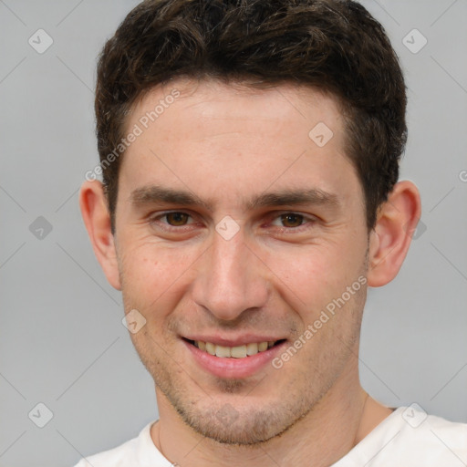 Joyful white young-adult male with short  brown hair and brown eyes