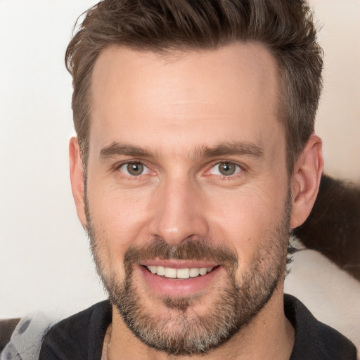 Joyful white adult male with short  brown hair and brown eyes