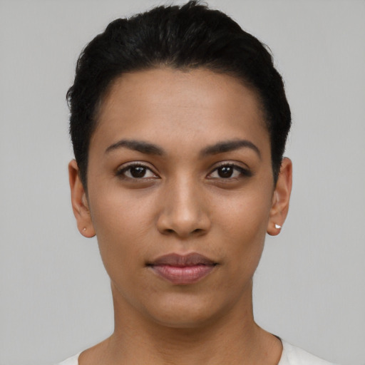 Joyful latino young-adult female with short  black hair and brown eyes