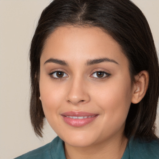 Joyful white young-adult female with medium  brown hair and brown eyes