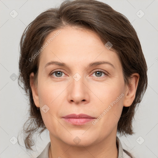 Joyful white adult female with medium  brown hair and grey eyes