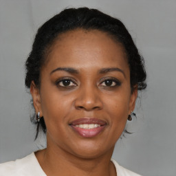 Joyful black young-adult female with medium  brown hair and brown eyes