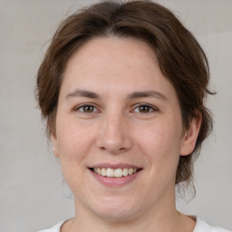 Joyful white young-adult female with medium  brown hair and brown eyes