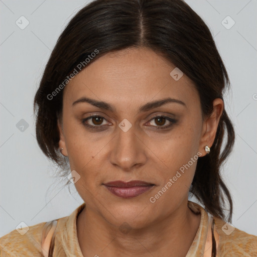 Joyful latino adult female with medium  brown hair and brown eyes