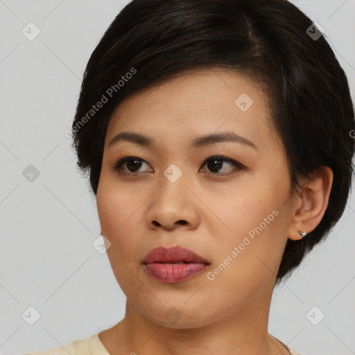 Joyful asian young-adult female with medium  black hair and brown eyes