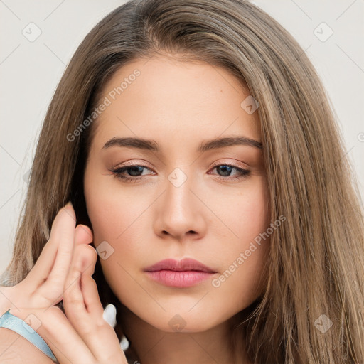 Neutral white young-adult female with long  brown hair and brown eyes