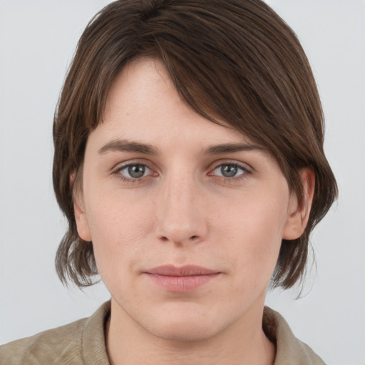 Joyful white young-adult female with medium  brown hair and grey eyes