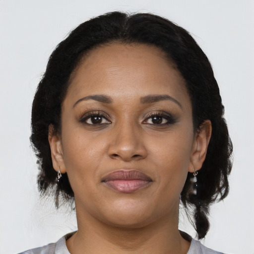 Joyful black young-adult female with medium  black hair and brown eyes