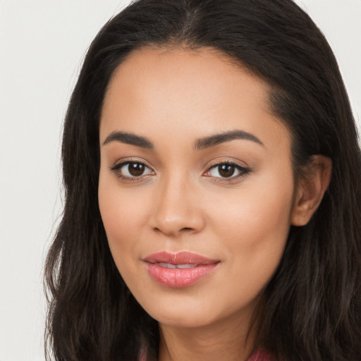 Joyful latino young-adult female with long  brown hair and brown eyes