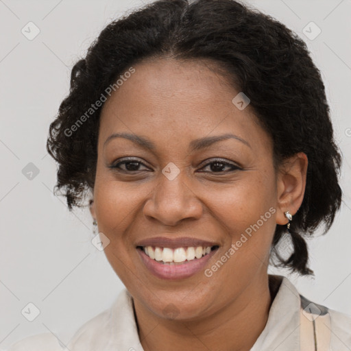 Joyful black adult female with medium  brown hair and brown eyes