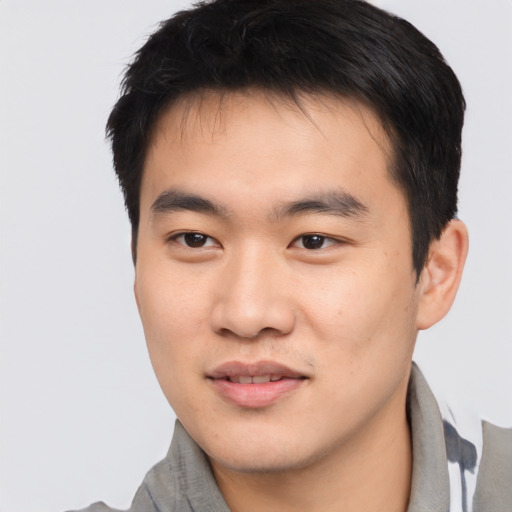 Joyful asian young-adult male with short  black hair and brown eyes