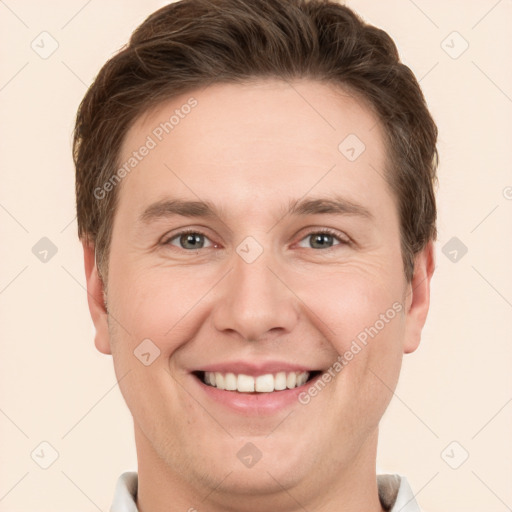 Joyful white young-adult male with short  brown hair and grey eyes