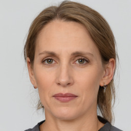 Joyful white adult female with medium  brown hair and grey eyes