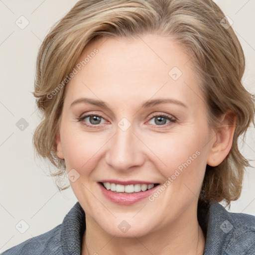 Joyful white adult female with medium  brown hair and blue eyes