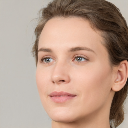 Joyful white young-adult female with medium  brown hair and green eyes