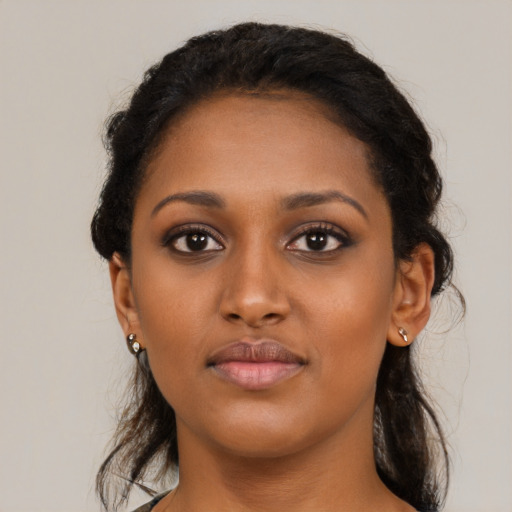Neutral black young-adult female with long  brown hair and brown eyes