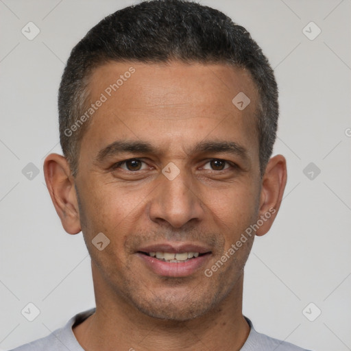 Joyful latino young-adult male with short  brown hair and brown eyes