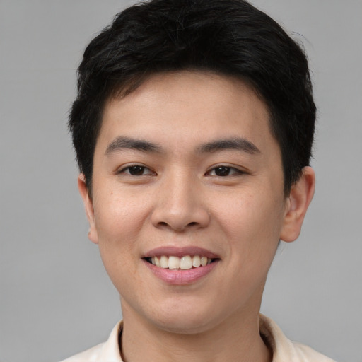 Joyful asian young-adult male with short  brown hair and brown eyes
