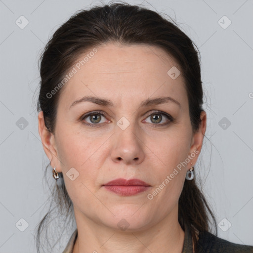 Joyful white adult female with medium  brown hair and grey eyes