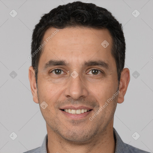 Joyful white adult male with short  black hair and brown eyes