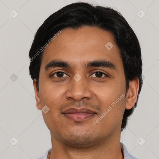 Joyful latino young-adult male with short  black hair and brown eyes