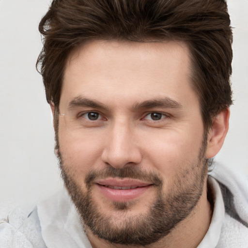 Joyful white young-adult male with short  brown hair and brown eyes