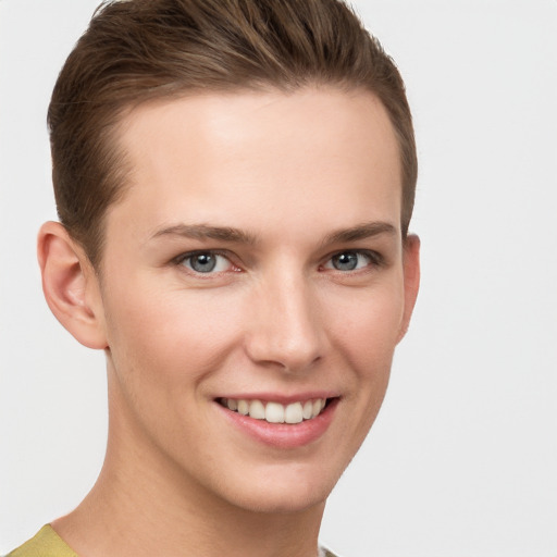 Joyful white young-adult female with short  brown hair and grey eyes