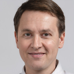 Joyful white adult male with short  brown hair and grey eyes