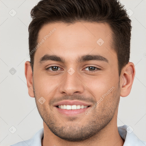 Joyful white young-adult male with short  brown hair and brown eyes