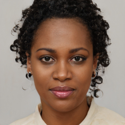 Joyful black young-adult female with medium  brown hair and brown eyes