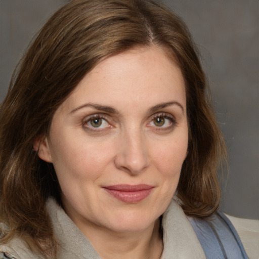 Joyful white adult female with medium  brown hair and brown eyes