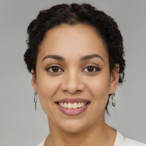 Joyful latino young-adult female with short  brown hair and brown eyes