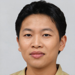 Joyful asian young-adult male with short  black hair and brown eyes