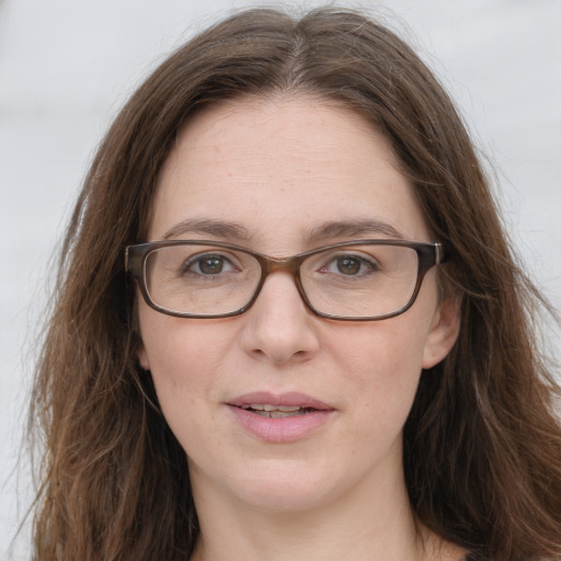 Joyful white young-adult female with long  brown hair and green eyes