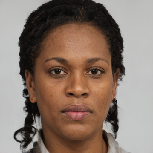 Joyful black adult female with short  brown hair and brown eyes
