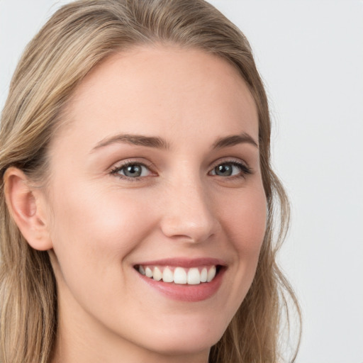 Joyful white young-adult female with long  brown hair and grey eyes