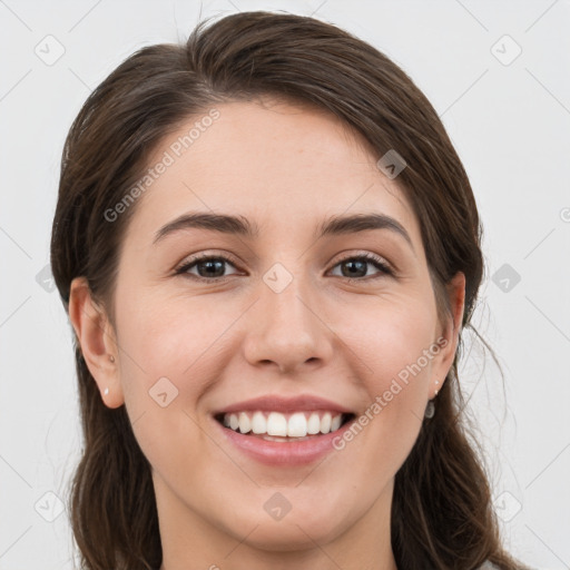 Joyful white young-adult female with long  brown hair and grey eyes