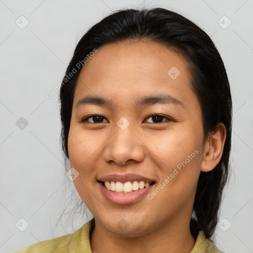 Joyful asian young-adult female with medium  brown hair and brown eyes