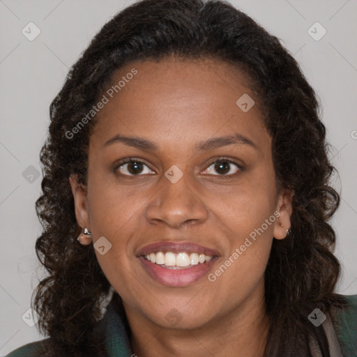 Joyful black young-adult female with long  brown hair and brown eyes