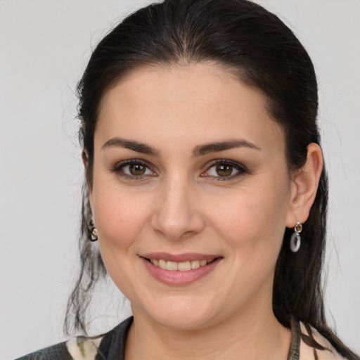 Joyful white young-adult female with medium  brown hair and brown eyes